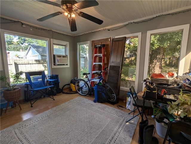 sunroom with ceiling fan and cooling unit