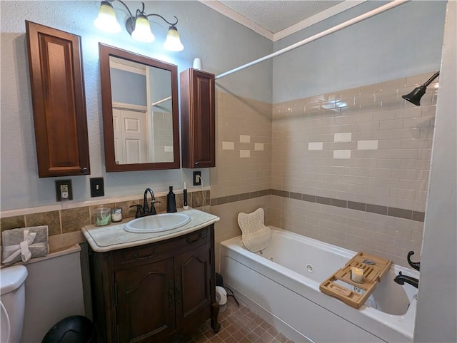 full bathroom featuring a textured ceiling, tiled shower / bath combo, vanity, and toilet