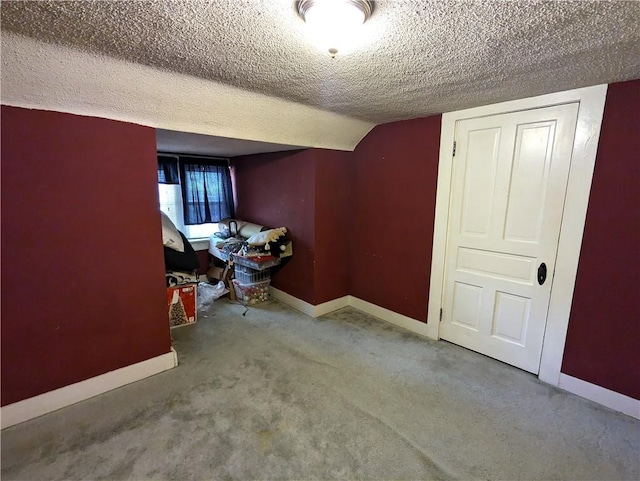 interior space with lofted ceiling and a textured ceiling