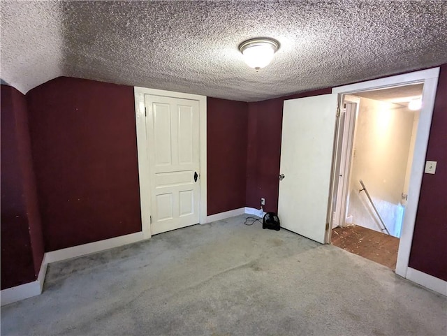 unfurnished bedroom with light carpet and a textured ceiling