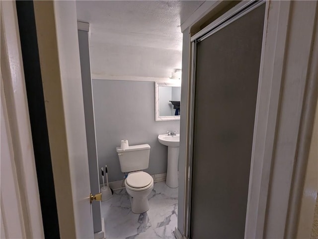 bathroom with an enclosed shower and toilet