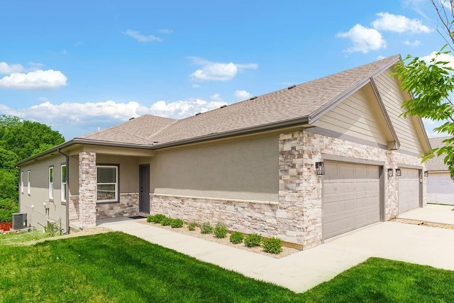 view of home's exterior featuring central AC unit, concrete driveway, stone siding, a yard, and stucco siding