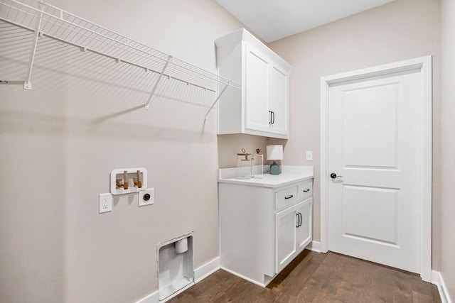 laundry room featuring baseboards, electric dryer hookup, cabinet space, washer hookup, and dark wood-style flooring