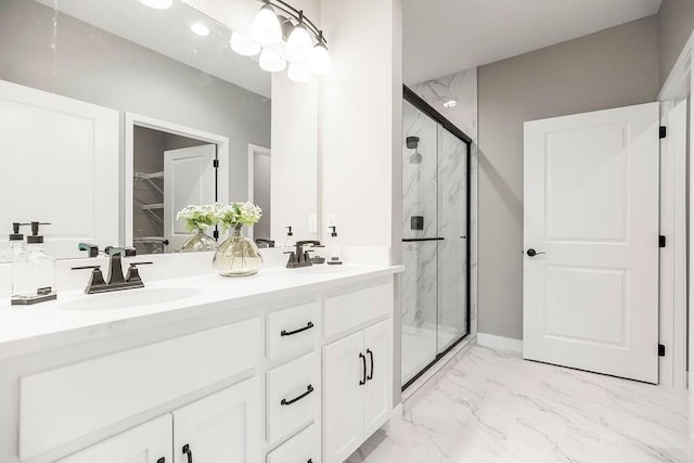 full bathroom featuring marble finish floor, a sink, and a marble finish shower