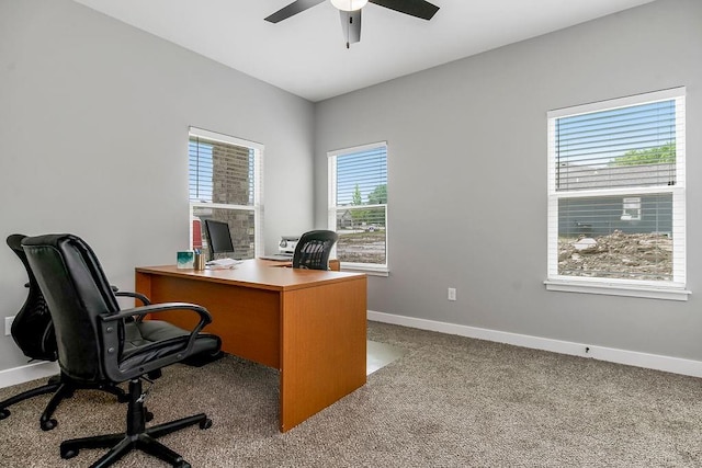 carpeted office featuring baseboards and ceiling fan