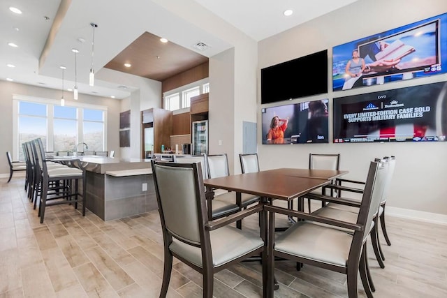 dining area with baseboards, recessed lighting, and light wood-type flooring