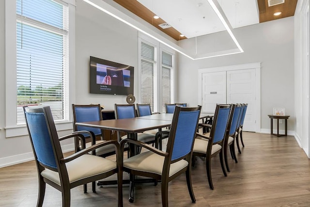 dining area with baseboards, visible vents, and light wood-type flooring