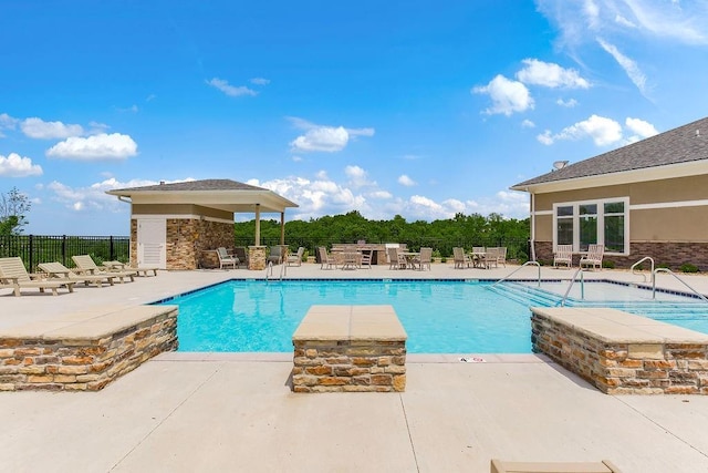 pool featuring fence and a patio area