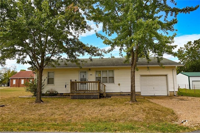 ranch-style house with a garage, a deck, and a front lawn