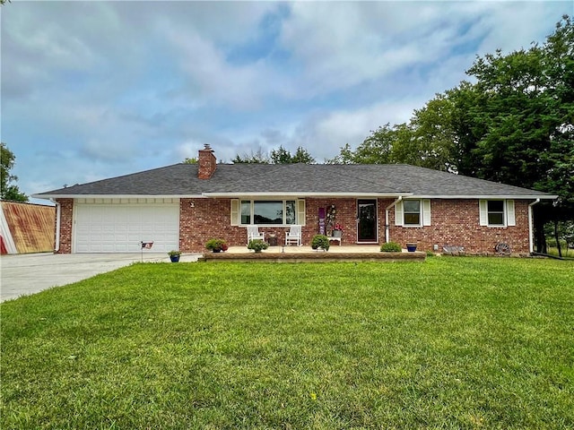 single story home with a porch, concrete driveway, brick siding, and a front yard