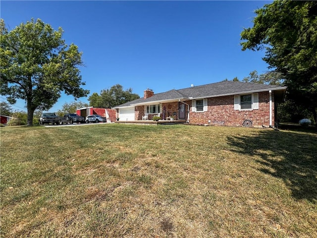 ranch-style house featuring a garage, brick siding, a chimney, a front yard, and driveway