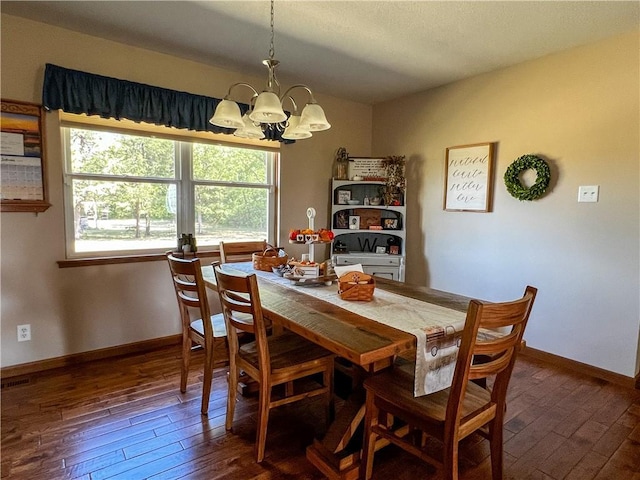 dining space with a chandelier, dark wood-type flooring, and baseboards