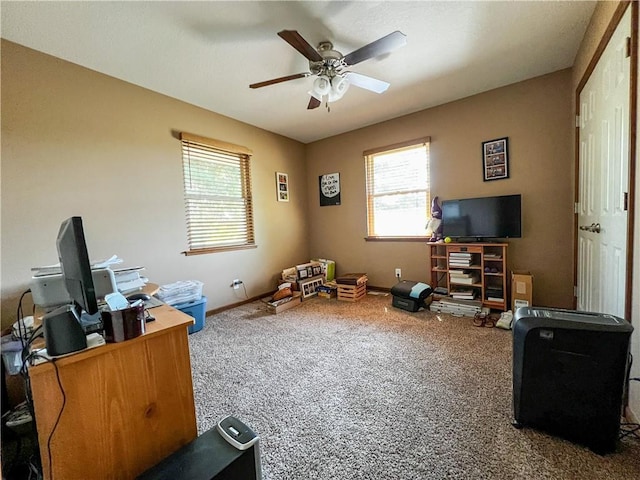 carpeted home office with plenty of natural light, ceiling fan, and baseboards