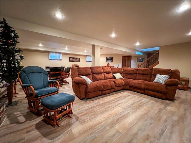 living area featuring light wood-type flooring, recessed lighting, and stairs