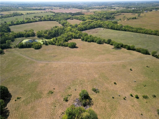 birds eye view of property with a rural view