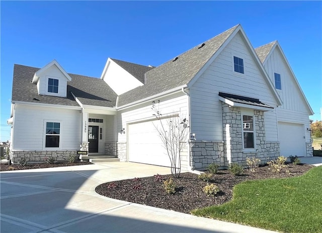 13485 W 174th Pl, Overland Park, KS 66221 - view of front facade with stone siding, a garage, driveway, and a shingled roof
