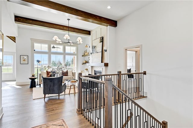 13485 W 174th Pl, Overland Park, KS 66221 - hall with a chandelier, wood finished floors, a towering ceiling, an upstairs landing, and beamed ceiling