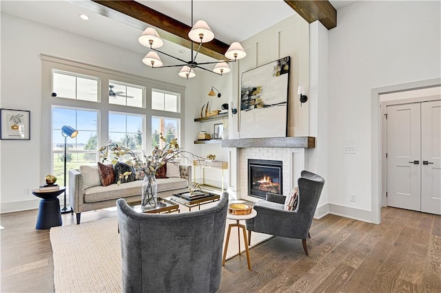 13485 W 174th Pl, Overland Park, KS 66221 - living room with a towering ceiling, beamed ceiling, plenty of natural light, wood finished floors, and a chandelier