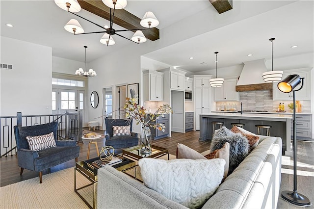 13485 W 174th Pl, Overland Park, KS 66221 - living room featuring a chandelier, wood finished floors, beamed ceiling, recessed lighting, and a towering ceiling