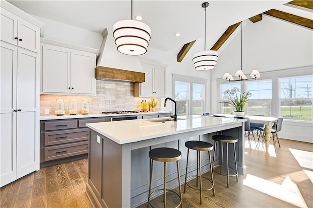 13485 W 174th Pl, Overland Park, KS 66221 - kitchen with light countertops, plenty of natural light, tasteful backsplash, an island with sink, and recessed lighting