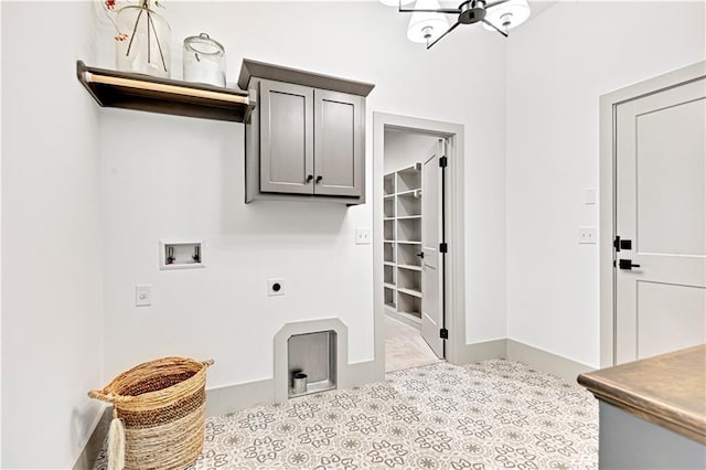 13485 W 174th Pl, Overland Park, KS 66221 - washroom with cabinet space, electric dryer hookup, washer hookup, tile patterned flooring, and a chandelier