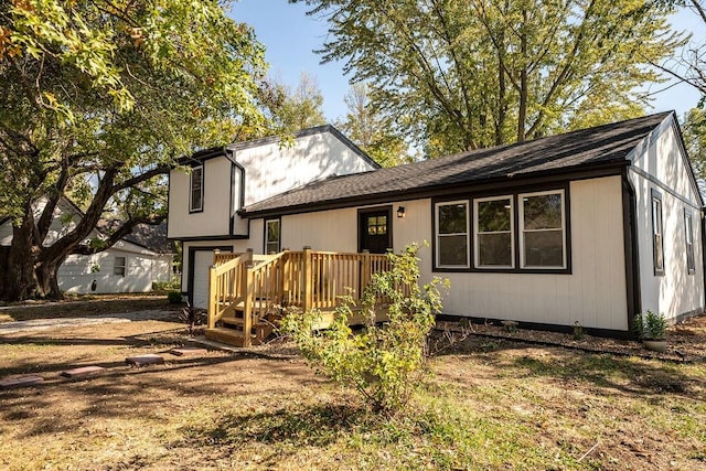 rear view of property with a wooden deck