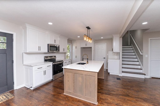 kitchen with white cabinets, stainless steel appliances, plenty of natural light, and sink