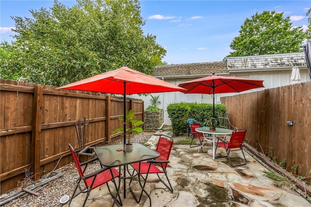 view of patio with a fenced backyard and outdoor dining space