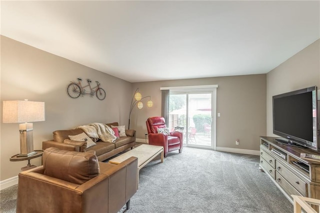 carpeted living room featuring baseboards