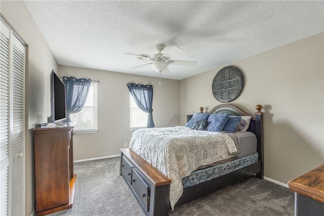 bedroom with ceiling fan, a textured ceiling, carpet, and baseboards