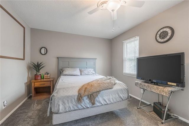 carpeted bedroom with a textured ceiling, a ceiling fan, and baseboards