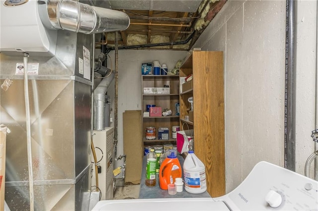 utility room featuring washer / clothes dryer and heating unit