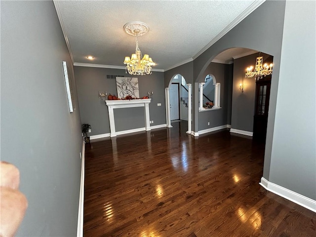 unfurnished dining area featuring ornamental molding, a textured ceiling, and dark wood-type flooring