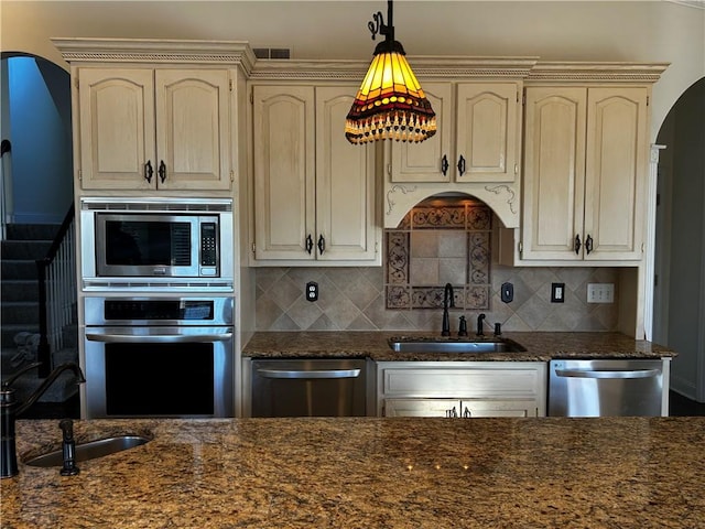 kitchen featuring cream cabinets, appliances with stainless steel finishes, and sink