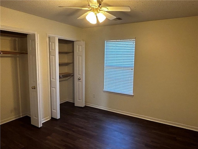 unfurnished bedroom featuring a textured ceiling, ceiling fan, and dark hardwood / wood-style flooring