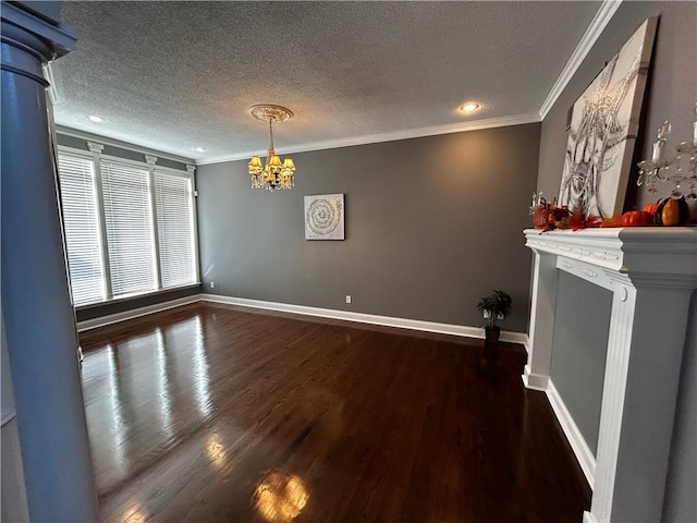 unfurnished living room featuring a textured ceiling, crown molding, dark wood-type flooring, and a chandelier