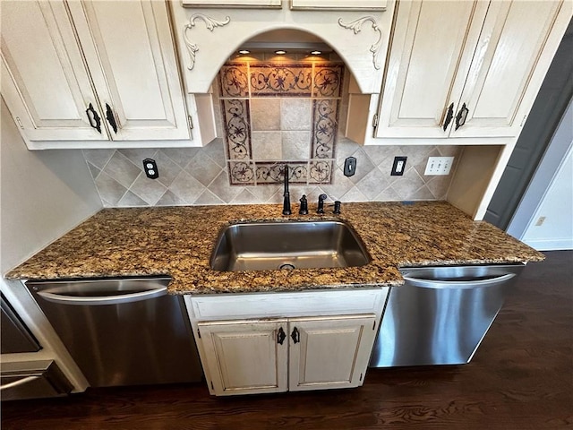 kitchen with dark stone countertops, white cabinets, dark hardwood / wood-style floors, and sink