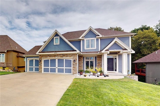 4602 NW Verona Dr, Riverside, MO 64150 - craftsman-style home with driveway, a front yard, stone siding, and an attached garage