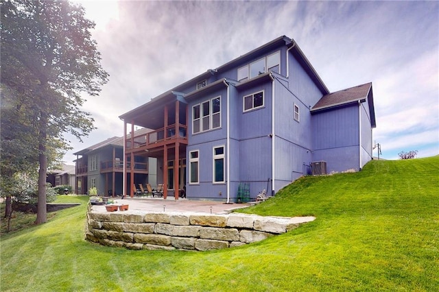 rear view of house featuring a patio, a yard, and central air condition unit