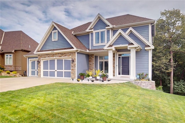 craftsman-style home featuring a front yard and a garage