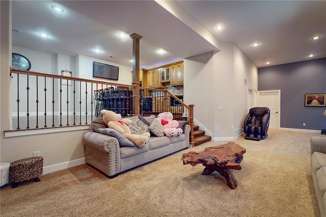 carpeted living room featuring decorative columns