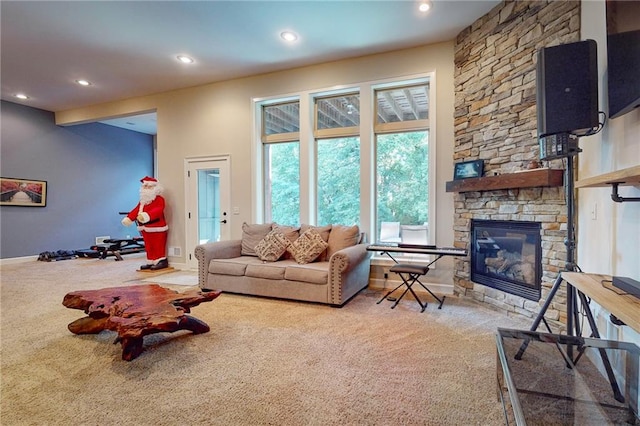 carpeted living room featuring a stone fireplace