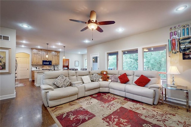 living room with wood-type flooring and ceiling fan