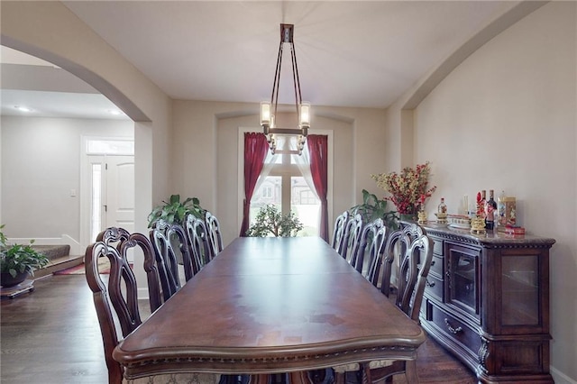 dining space with dark wood-type flooring