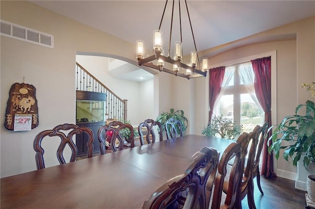 dining room featuring an inviting chandelier and dark hardwood / wood-style flooring