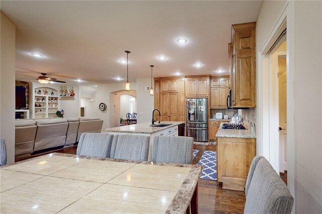 4602 NW Verona Dr, Riverside, MO 64150 - dining area featuring recessed lighting, arched walkways, dark wood-style floors, a ceiling fan, and built in shelves