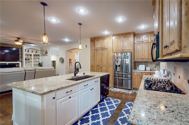 kitchen with dark hardwood / wood-style floors, sink, black appliances, a center island with sink, and ceiling fan