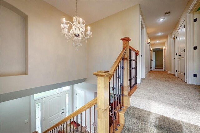 4602 NW Verona Dr, Riverside, MO 64150 - staircase with a chandelier, recessed lighting, carpet flooring, and baseboards