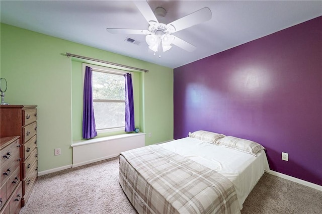 bedroom with ceiling fan and light colored carpet