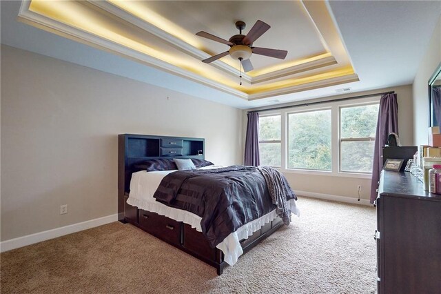 4602 NW Verona Dr, Riverside, MO 64150 - bedroom featuring a raised ceiling, light colored carpet, baseboards, and ceiling fan